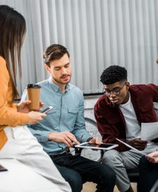 multicultural-young-businesspeople-discussing-new-business-idea-in-office.jpg